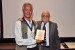 Dr. Nagib Callaos, General Chair, giving Dr. Richard Self a plaque "In Appreciation for Delivering a Great Keynote Address at a Plenary Session."